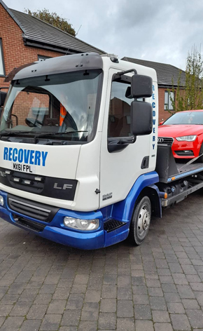 Breakdown Sheffield recovery truck loading car outside home driveway for repair