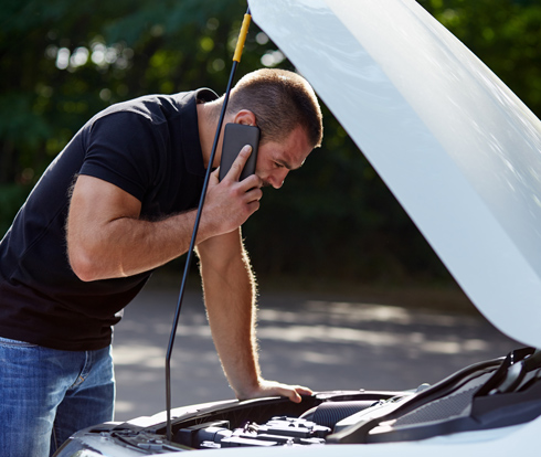 man calling for car breakdown help and assistance on roadside