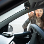 woman looking at keys locked in car on dashboard