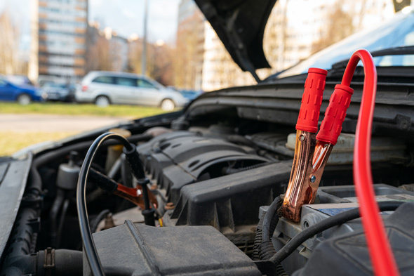 jump cables on car low power battery, broken car start attempt concept